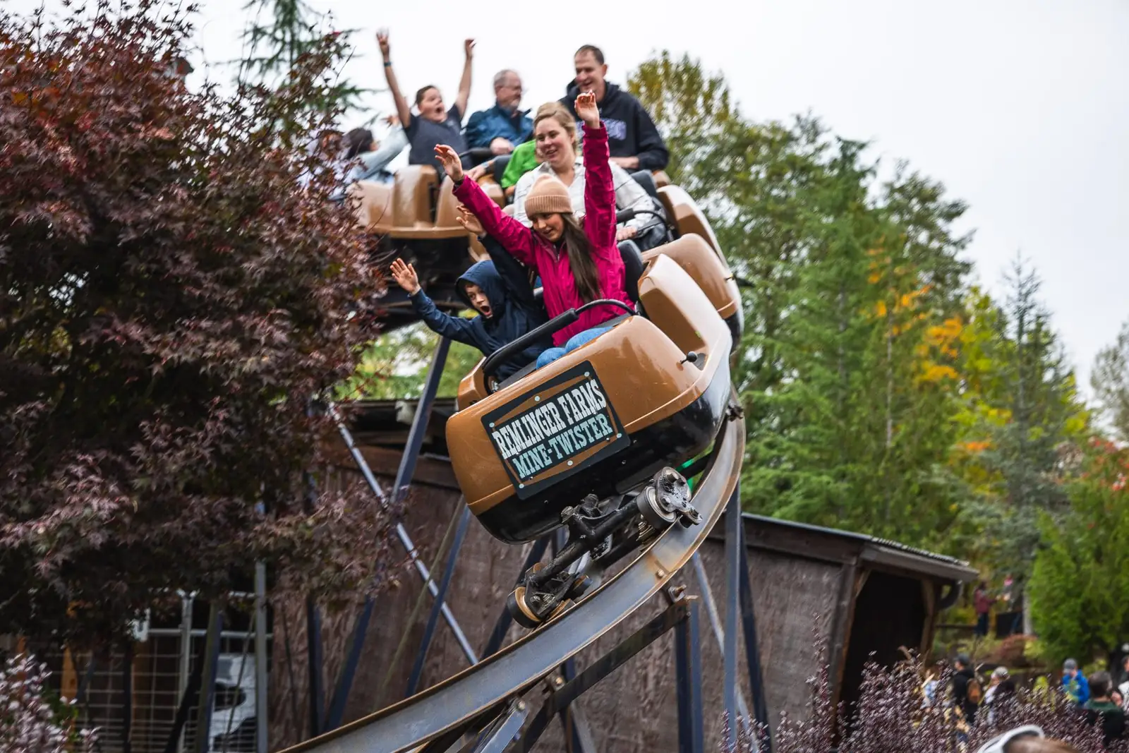 Riders with their arms up on the Remlinger Farms Mine-Twister coaster