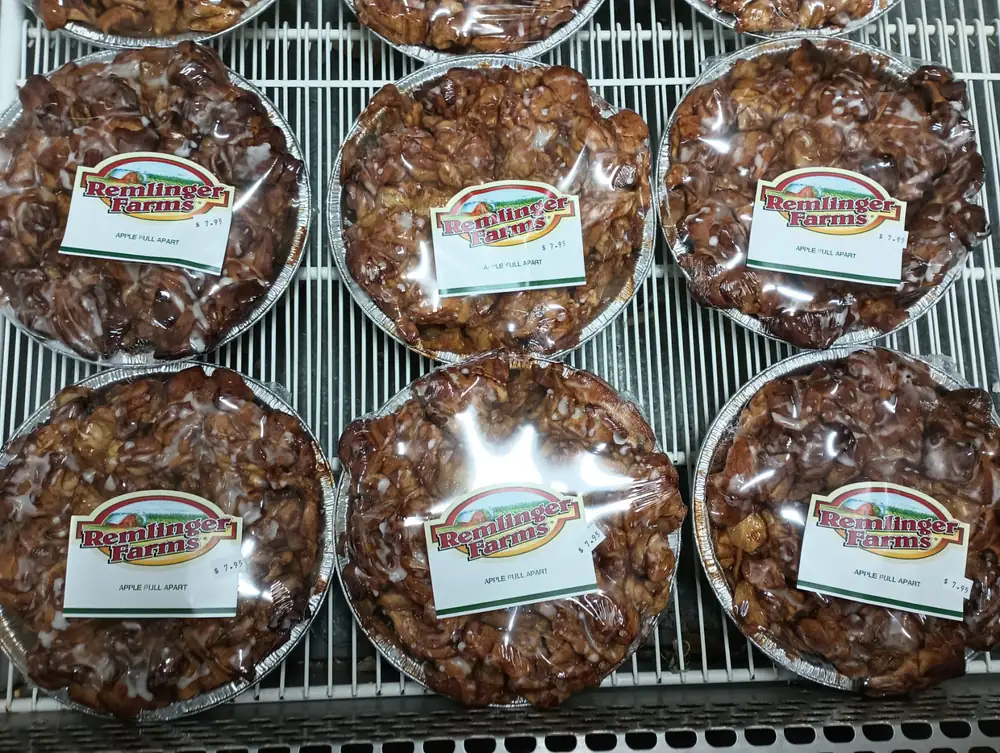 Trays of glazed apple pull-apart bread in the farm market case