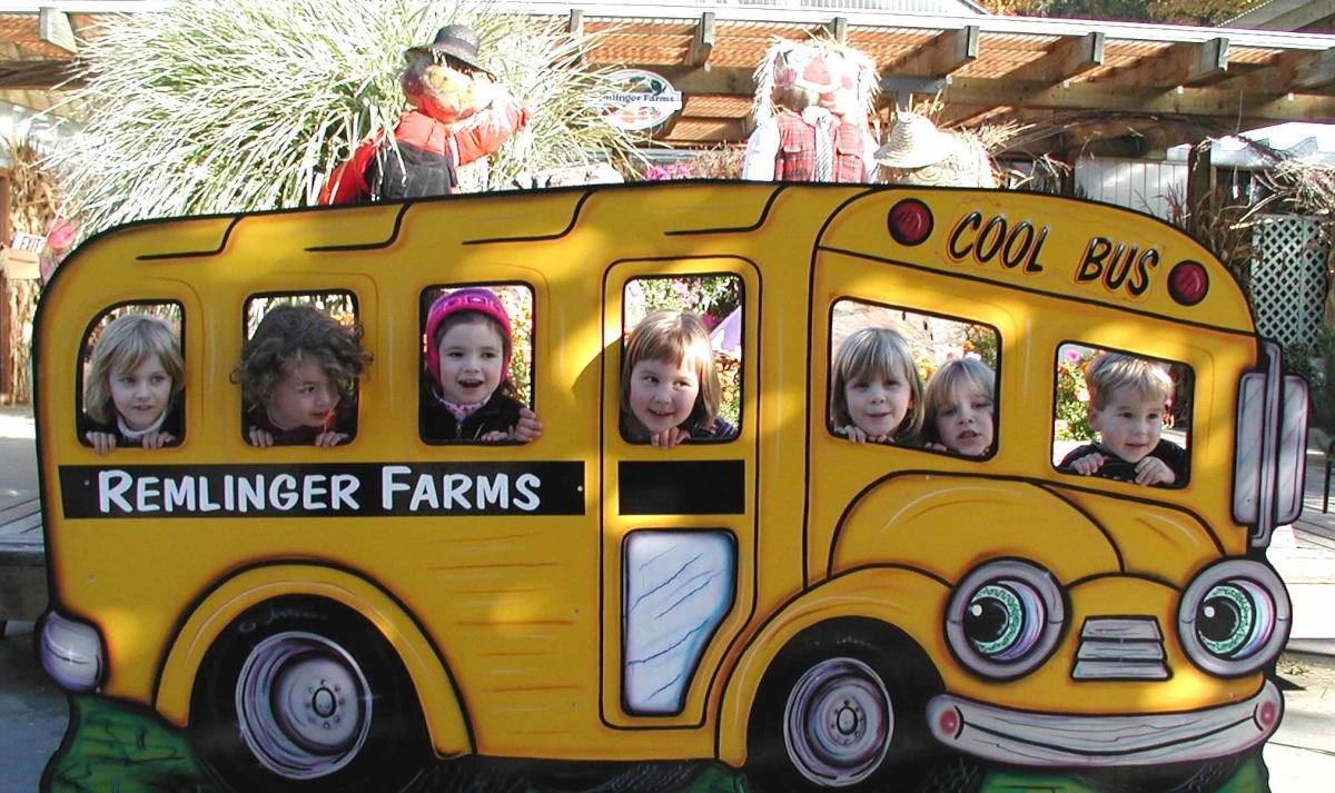 A family walking the pumpkin field on a self-guided tour day at Remlinger Farms